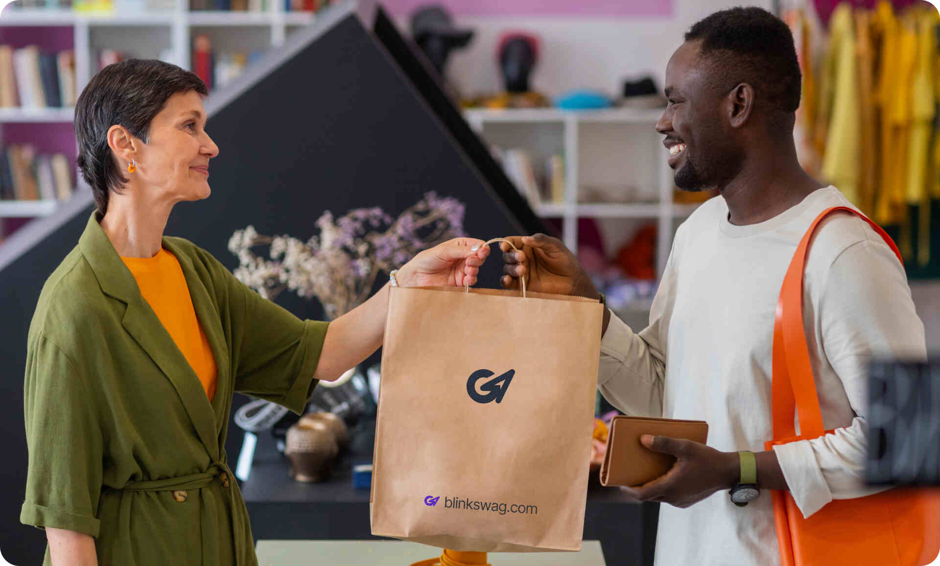 a women handing over a shopping bag to a black man
