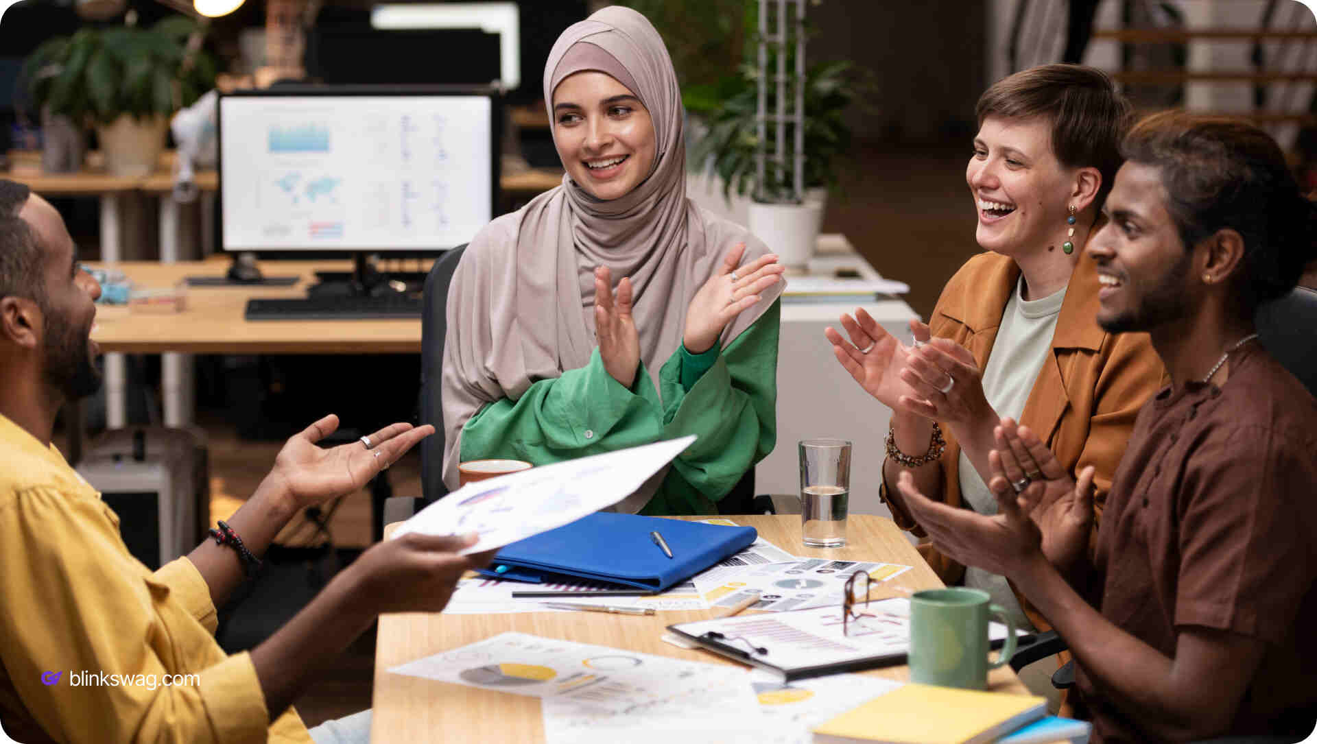 employees cheering together in a office