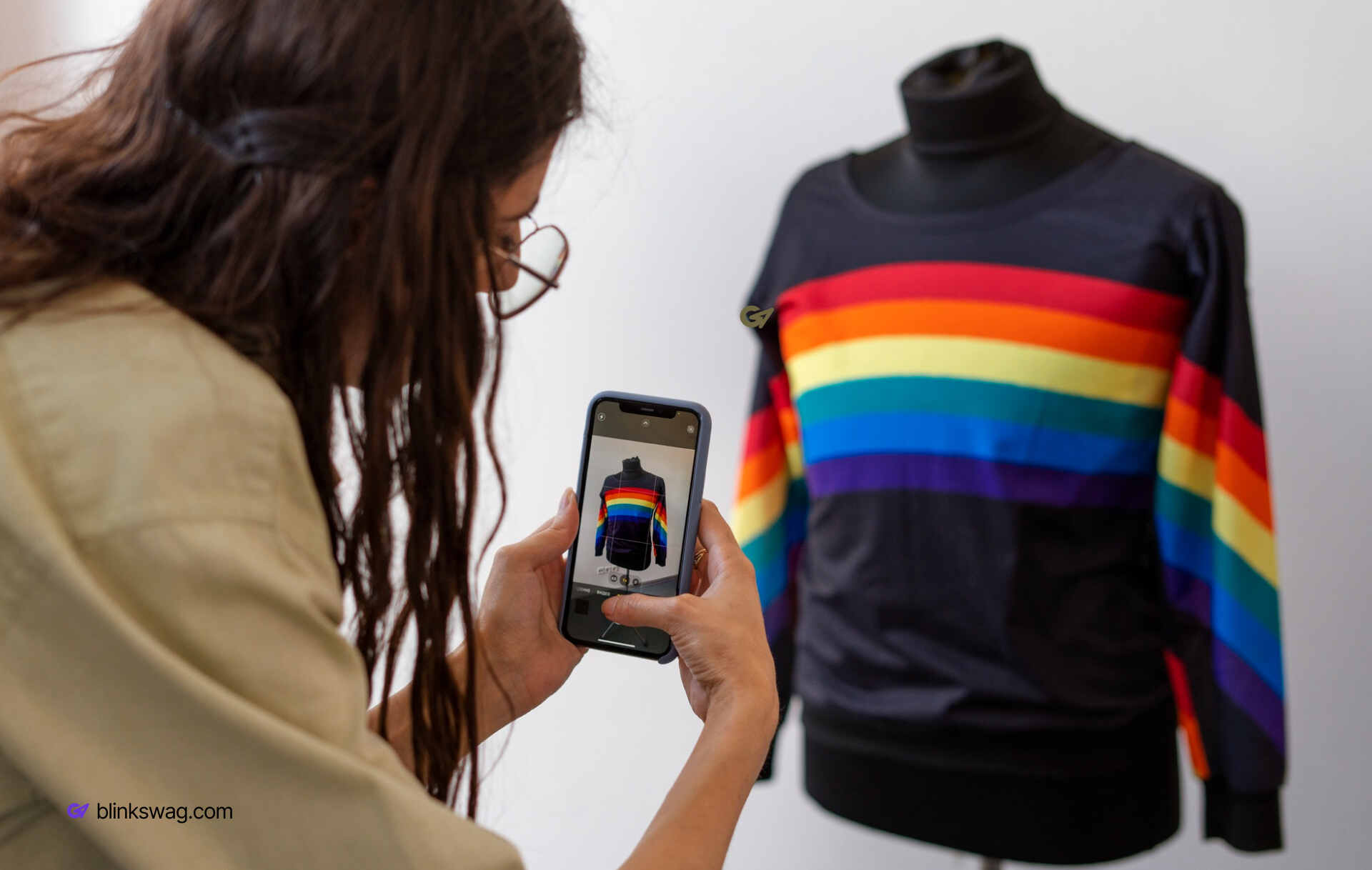 a woman takng picture of a pride theme sweater
