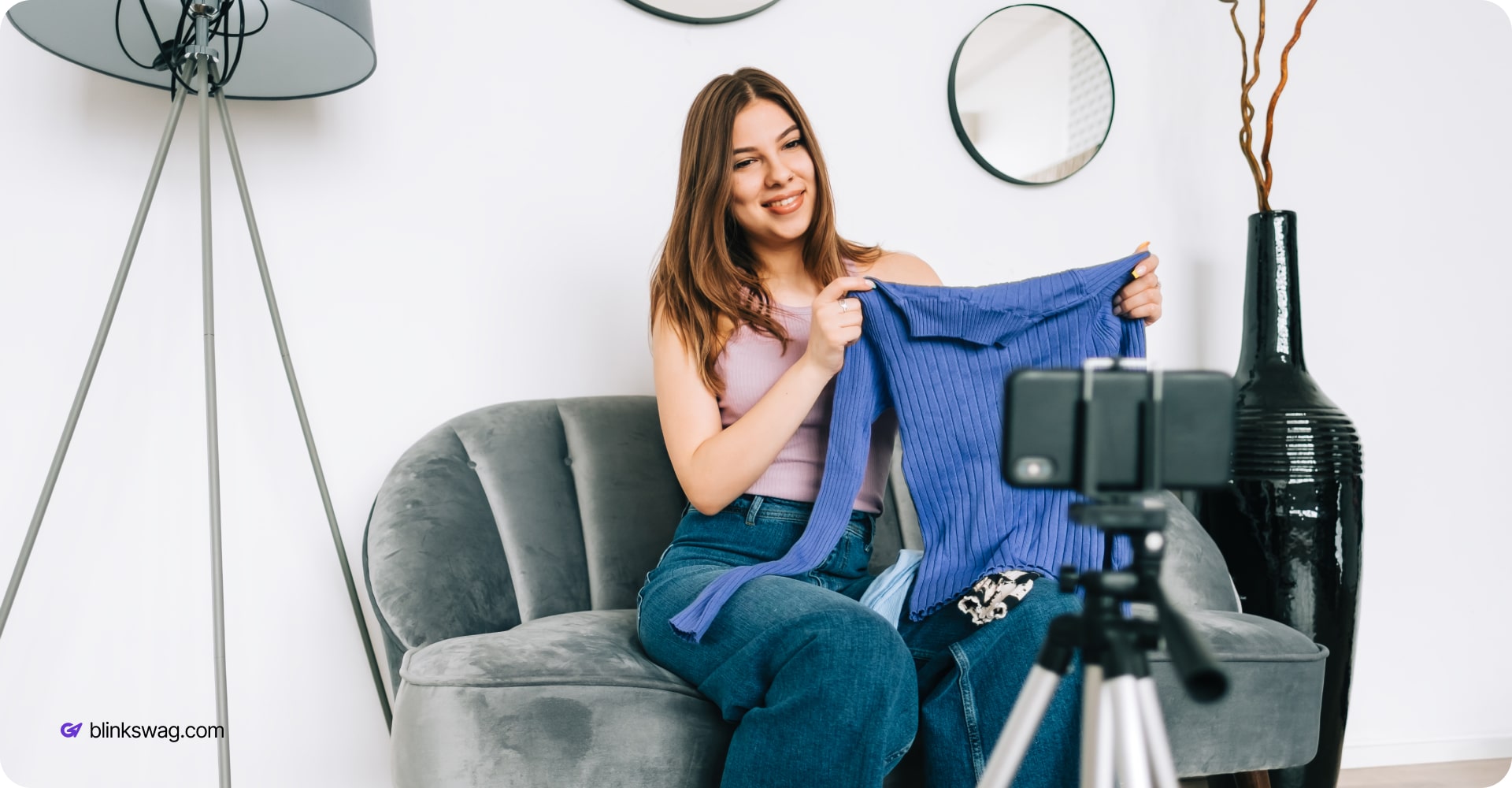 influencer holding a branded sweater