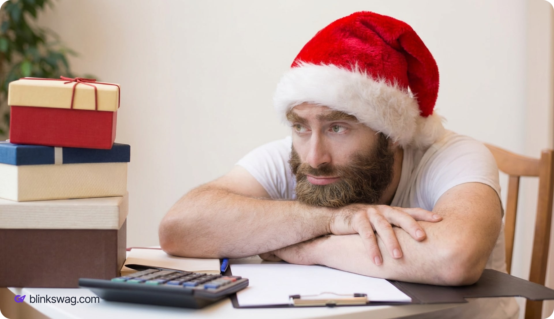 a person with santa cap thinking with a calculator and gift boxes