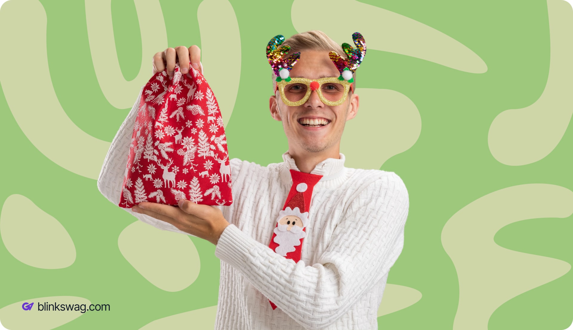 a person holding Christmas gift bag while wearing Christmas swag