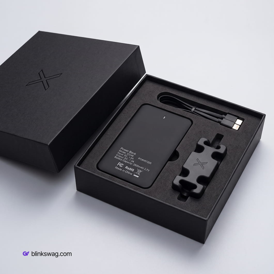 Black custom power bank set in a luxury box with a charging cable and cable manager cordbrick.