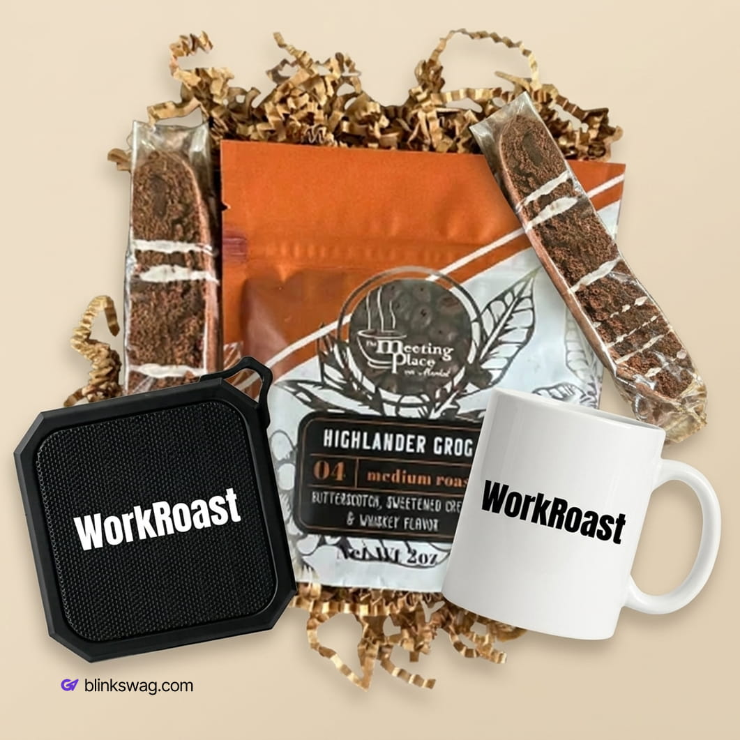 custom WorkRoast coffee kit gift box featuring a black portable speaker, white ceramic coffee mug, bag of Highlander Grog coffee, and two packaged chocolate biscotti treats.