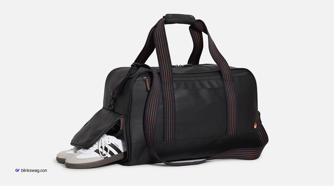 Black Marine Layer weekender duffel bag featuring patterned webbed handles and a dedicated side shoe compartment.